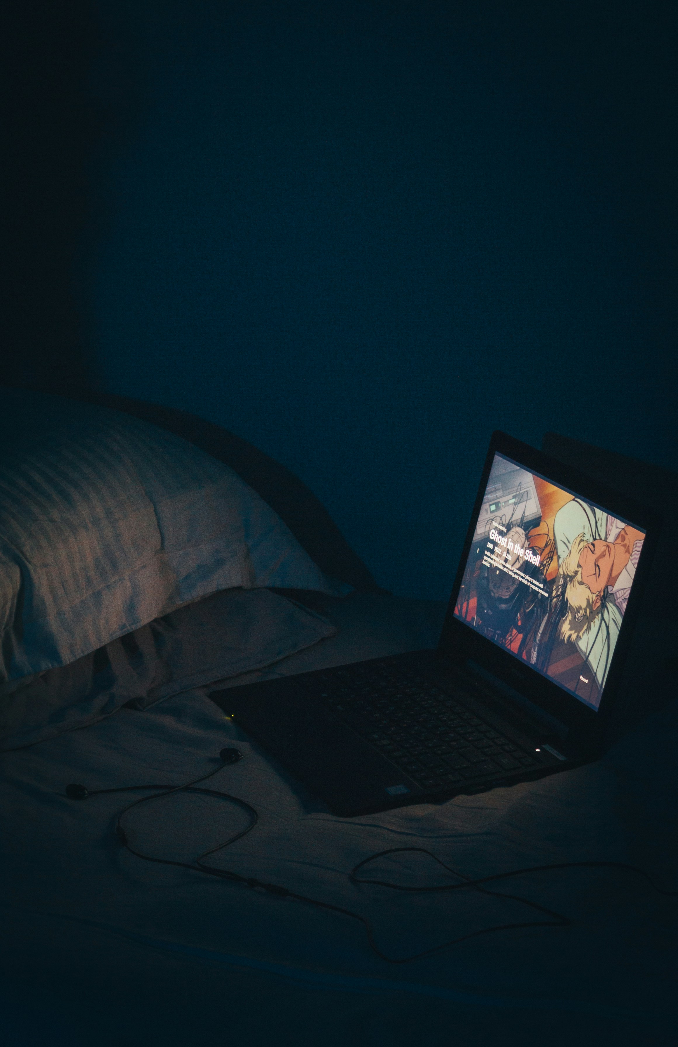 Person watching content on a laptop in bed