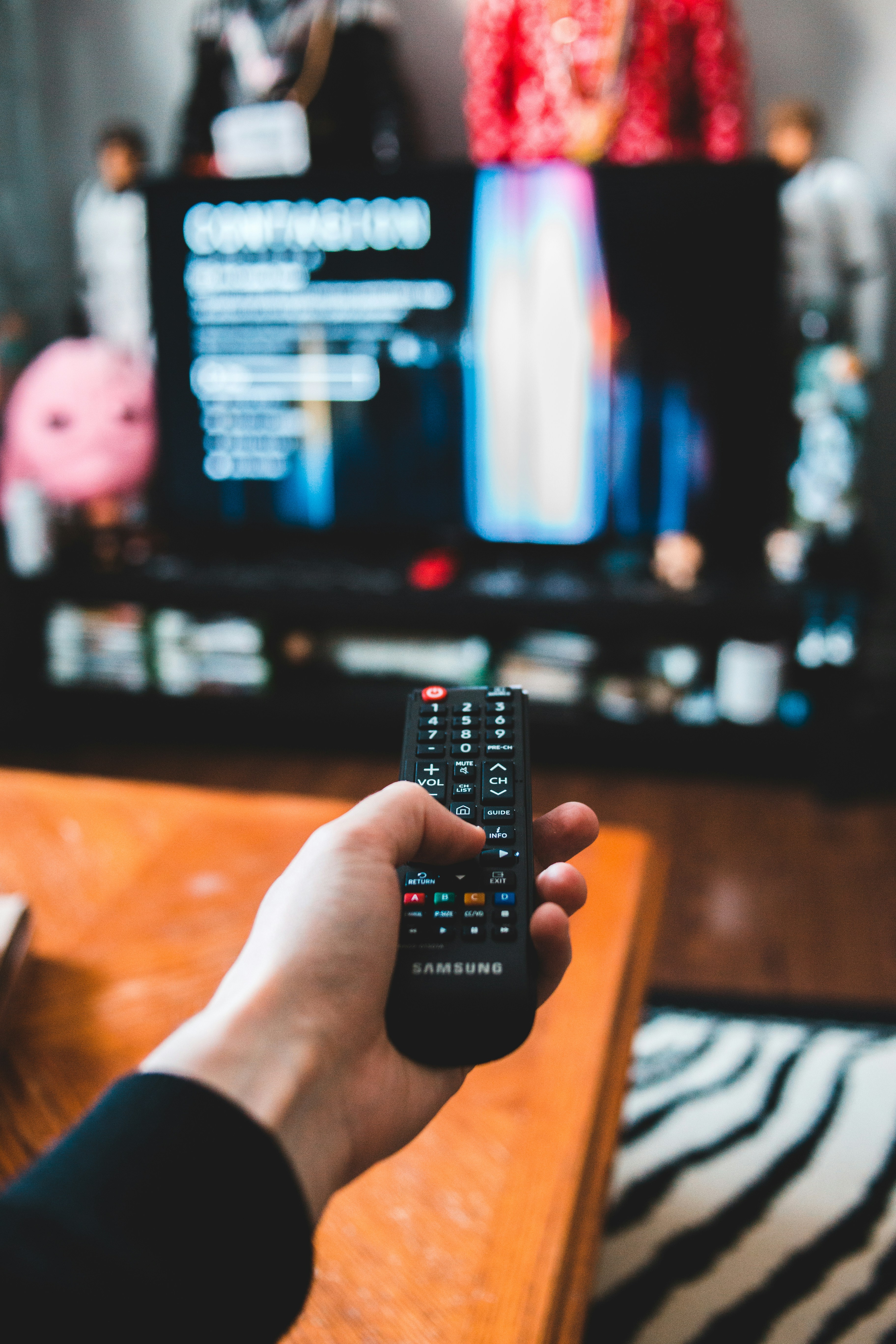 Person using a remote control to navigate streaming content