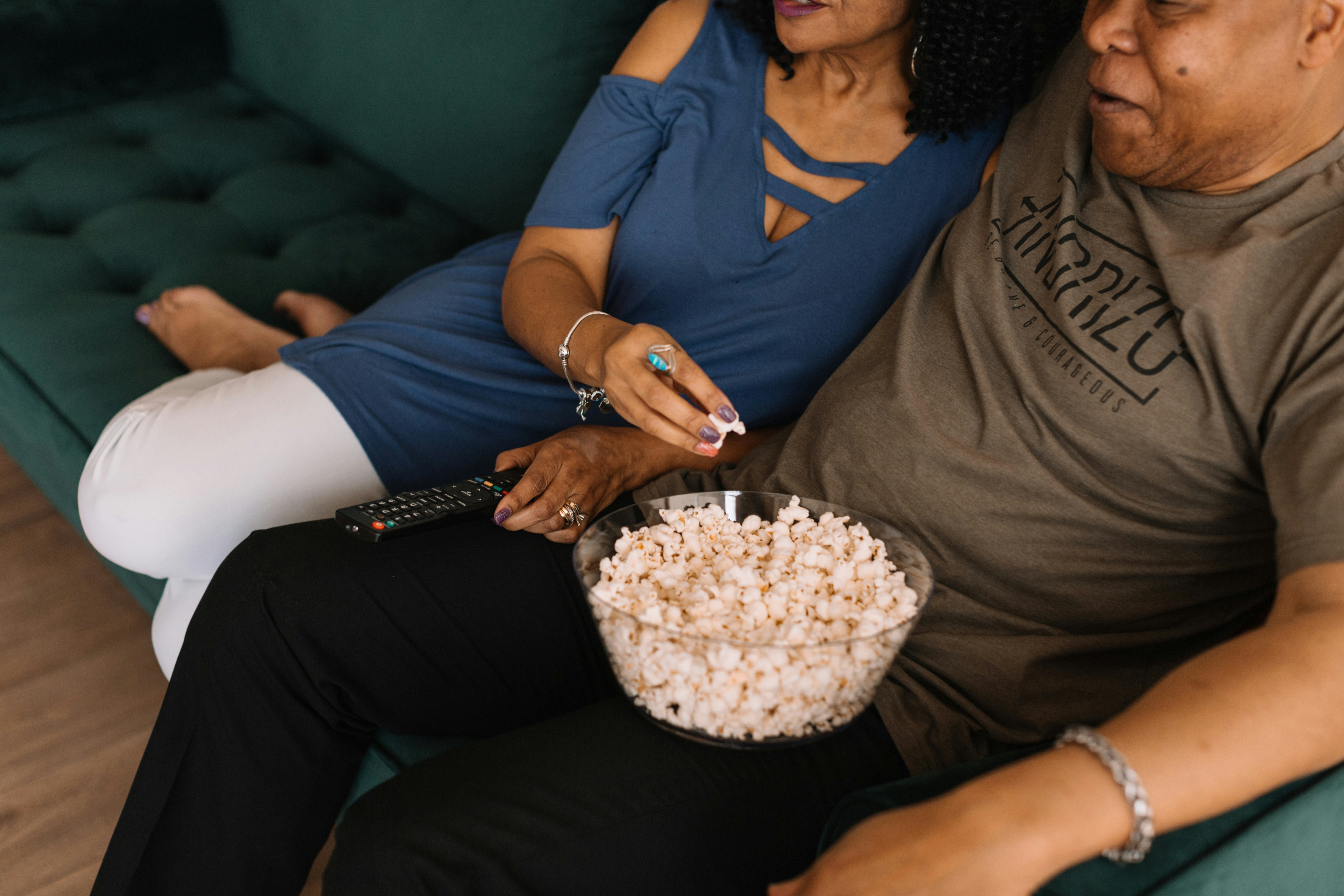 Couple watching TV with popcorn