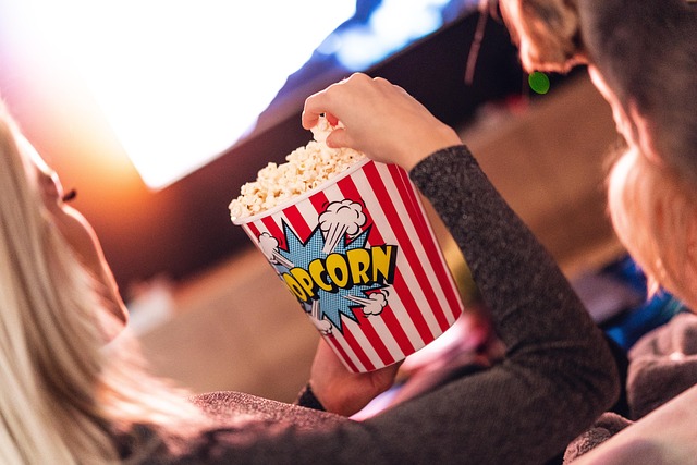 Girl watching content with popcorn