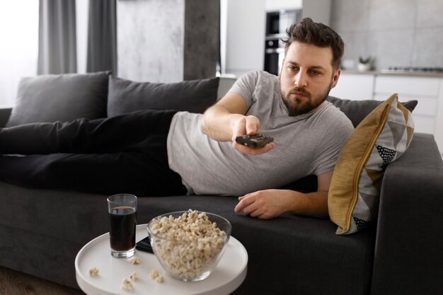 Young man watching tv on the sofa at home